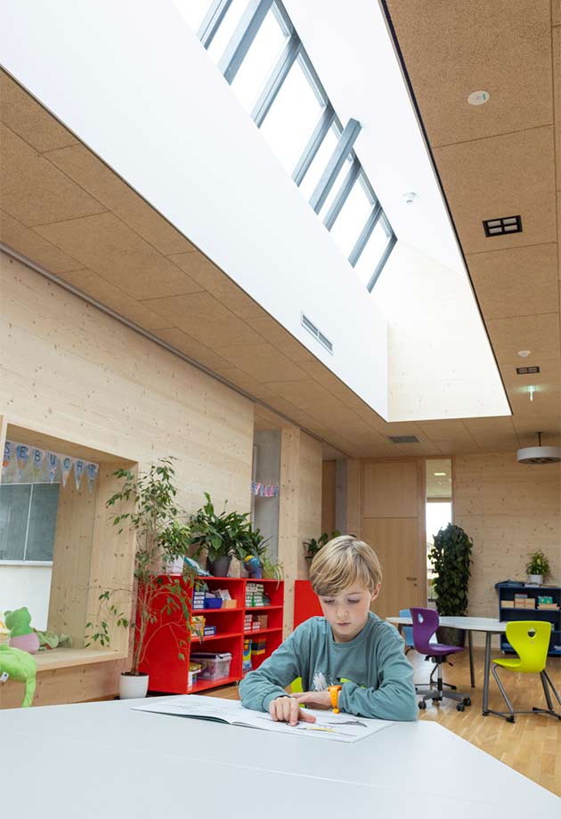 Child reads under VELUX Modular Skylights