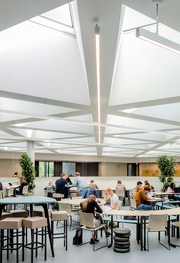 Students enjoying the daylight in the Knippenberg College under VELUX Commercial product.
