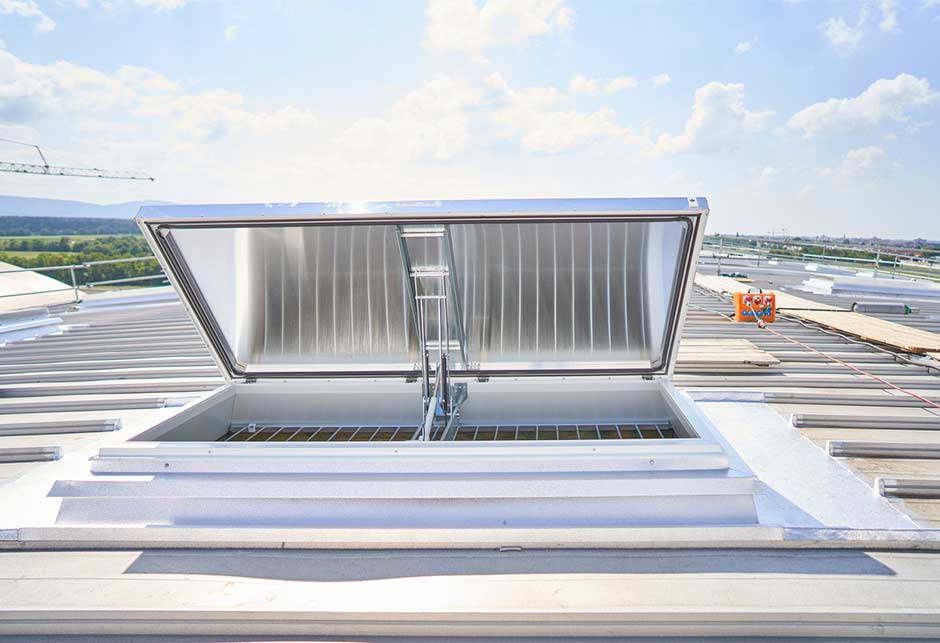 Rooflights with aluminium lids and fall-through prevention grid in ventilation position